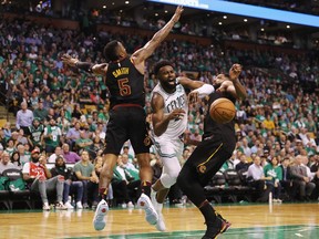 Jaylen Brown #7 of the Boston Celtics loses the ball as he drives to the basket against JR Smith #5 and Tristan Thompson #13 of the Cleveland Cavaliers in the second half during Game Five of the 2018 NBA Eastern Conference Finals at TD Garden on May 23, 2018 in Boston, Massachusetts.