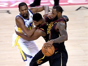 LeBron James #23 of the Cleveland Cavaliers dribbles around Tristan Thompson #13 defended by Kevin Durant #35 of the Golden State Warriors in Game 1 of the 2018 NBA Finals at ORACLE Arena on May 31, 2018 in Oakland, California.