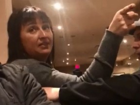 An unidentified woman engages in an argument with a group of patrons at a restaurant in Lethbridge, Alta., in this screengrab from an undated video posted on Facebook.