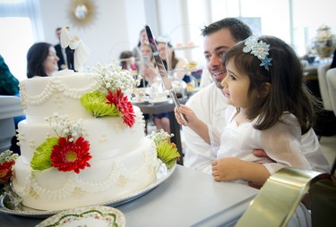 Nour Shaaban cuts the cake with Fairmont Château Laurier's executive chef Louis Simard.