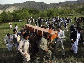 Relatives, colleagues and friends of AFP chief photographer, Shah Marai, who was killed in today's second suicide attack, carry his coffin in his village, Guldara, a district of Kabul province, Afghanistan, Monday, April 30, 2018. A coordinated double suicide bombing by the Islamic State group in central Kabul has killed at least 25 people, including several Afghan journalists.