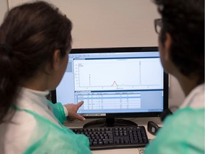 Doctors check results on a computer.