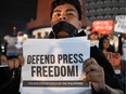 In this file photo taken on January 19, 2018,  a protester displays a placard calling for press freedom in Manila.