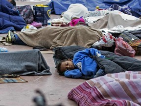 Central American migrants travelling in the 'Migrant Via Crucis' caravan sleep outside the El Chaparral port of entry to the U.S. while waiting to be received by authorities, in Tijuana, Baja California State, Mexico on April 30, 2018.