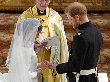 US fiancee of Britain's Prince Harry Meghan Markle (L) and Britain's Prince Harry, Duke of Sussex exchange rings during their wedding ceremony in St George's Chapel, Windsor Castle, in Windsor, on May 19, 2018.