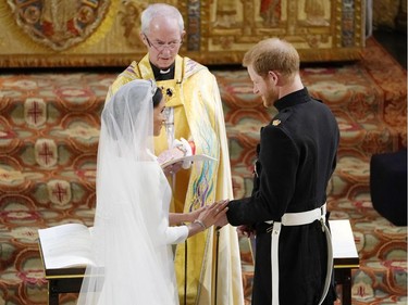 US fiancee of Britain's Prince Harry Meghan Markle (L) and Britain's Prince Harry, Duke of Sussex during their wedding ceremony in St George's Chapel, Windsor Castle, in Windsor, on May 19, 2018.