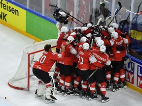 Switzerland's players celebrate after the semifinal match Canada vs Switzerland of the 2018 IIHF Ice Hockey World Championship at the Royal Arena in Copenhagen, Denmark, on May 19, 2018.