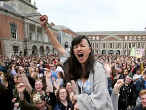 TOPSHOT - 'Yes' campaigners celebrate the official result of the Irish abortion referendum at Dublin Castle in Dublin on May 26, 2018 which showed a landslide decision in favour of repealing the constitutional ban on abortions.  Ireland voted by a landslide to ditch its strict abortion laws in a landmark referendum hailed by Prime Minister Leo Varadkar on Saturday as a "quiet revolution", triggering scenes of jubilation in Dublin. Final results showed 66 percent of voters in what has been a traditionally staunchly Catholic country backed repealing the constitutional ban on terminations.