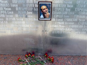 ]Flowers lay under a picture of the 41-year-old anti-Kremlin reporter Arkady Babchenko on the memorial wall of Moscow's journalists house in Moscow on May 30, 2018.