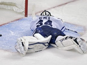 Toronto Maple Leafs goalie James Reimer lays on the ice after getting beat on the game winning goal by Boston Bruins center Patrice Bergeron during overtime in Game 7 of their NHL hockey Stanley Cup playoff series in Boston, Monday, May 13, 2013. The Bruins won 5-4. (AP Photo/Charles Krupa)