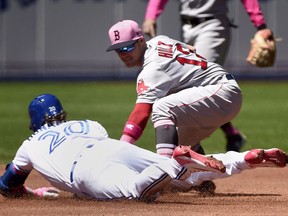 Toronto Blue Jays designated hitter Josh Donaldson (20) slides safe into second base after hitting a double and beating the tag from Boston Red Sox second baseman Brock Holt (12) during first inning American League MLB baseball action in Toronto on Sunday, May 13, 2018.