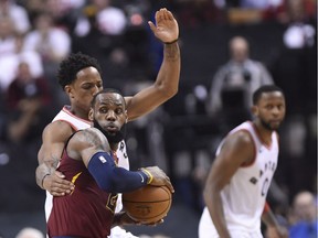 Cleveland Cavaliers forward LeBron James (23) looks for an outlet pass as Toronto Raptors guard DeMar DeRozan (10) defends during first half second round NBA playoff basketball action in Toronto on Tuesday, May 1, 2018.