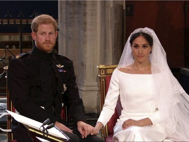 In this frame from video, Britain's Prince Harry and Meghan Markle listen at their wedding ceremony at St. George's Chapel in Windsor Castle in Windsor, near London, England, Saturday, May 19, 2018.