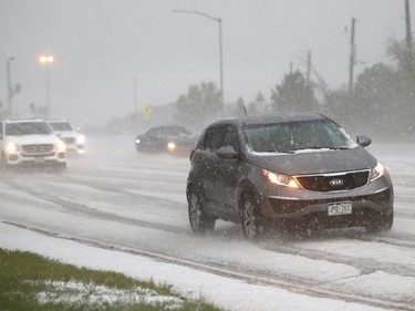 Motorists struggle to guide their vehicles through ruts of hail as it falls heavily on the westbound lanes of Hamden Avenue just west of Interstate 25, Monday, May 14, 2018, in southeast Denver. The high-powered storm swept over the area and dumped large amounts of marble-sized hail and heavy rain, snarling traffic in densely-populated parts of the metropolitan area.