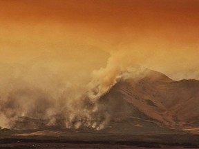 A large wild fire continues to burn in Waterton Lakes National Park, Alberta, on Tuesday, September 12, 2017. Federal researchers say Canada may be heading into another long, hot summer in the forests. Richard Carr of Natural Resources Canada says wildfire numbers are already ahead of the 10-year average.