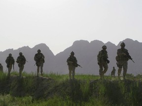 Canadian soldiers patrol an area in the Dand district of southern Afghanistan on Sunday, June 7, 2009. A network of mental-health clinics set up across the country to help veterans with PTSD and other psychological trauma appears in danger of being overwhelmed as an internal government report shows demand outstripping resources.THE CANADIAN PRESS/Colin Perkel