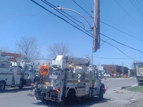 A hydro pole is suspended by power lines after a crash on Sheffield Road Thursday. Full photo below.