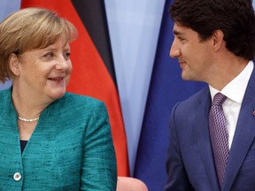 German Chancellor Angela Merkel talks with Canadian Prime Minister Justin Trudeau during the Women's Entrepreneurship Finance event at the G20 Summit, in Hamburg, Germany, Saturday, July 8, 2017.