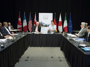 Prime Minister Justin Trudeau, centre right, meets with G7 Sherpas, in preparation for the summit, Thursday, May 24, 2018 in Baie-St-Paul, Que. Deputy Minister for the G7 Summit and Personal Representative of the Prime Minister Peter Boehm, centre left, looks on.