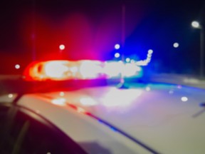 Red and blue Lights of police car in night time. Night patrolling the city. Abstract blurry image.