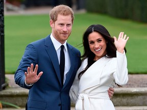 Prince Harry and Meghan Markle pose for the media in the grounds of Kensington Palace after announcing their engagement on Nov. 27, 2017.