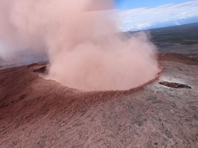 In this photo released by U.S. Geological Survey,  a plume of ash rises from the Puu Oo crater on Hawaii's Kilaueaa Volcano, Thursday, May 3, 2018 in Hawaii Volcanoes National Park. Hawaii's Kilauea volcano erupted Thursday, sending lava shooting into the air in a residential neighborhood and prompting mandatory evacuation orders for nearby homes. Hawaii County said steam and lava poured out of a crack in Leilani Estates, which is near the town of Pahoa on the Big Island. (U.S. Geolgogical Survey via AP) ORG XMIT: TKSK504