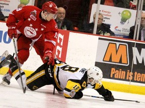 Hamilton Bulldogs Matthew Strome falls in front of So Greyhounds Joe Carroll during the first period of second game of OHL league championship at Essar Centre in Sault Ste. Marie, Ont,. on Saturday, May 5, 2018.