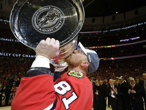 FILE - In this June 15, 2015, file photo, Chicago Blackhawks' Marian Hossa, of Slovakia, kisses the Stanley Cup after they defeated the Tampa Bay Lightning in Game 6 Chicago. Hossa says he's retiring because of health issues. In an interview with the Slovak newspaper Novy Cas, Hossa says he's done playing hockey. (AP/PHOTO)