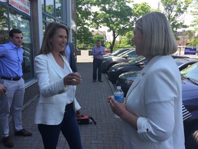 Caroline Mulroney, who’s running as the PC candidate in York-Simcoe, greets Ottawa South PC candidate Karin Howard at Howard’s campaign office Wednesday.