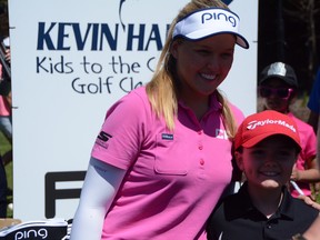 Brooke Henderson poses for a photo with a fan at Kids To the Course Classic held at Eagle Creek yesterday. Don Brennan/Ottawa Sun
