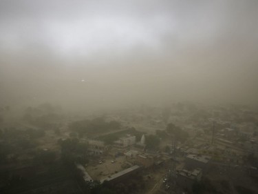 Village Itada is enveloped in thick blanket of dust during a dust storm in Noida near New Delhi, India, Sunday, May 13, 2018. The monsoon season is nearly six weeks away in India.