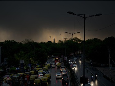 The Qutab Minar monument is silhouetted against a dark cloud covered skyline following a thunder storm in New Delhi, India, Sunday, May 13, 2018. The monsoon season is nearly six weeks away in India.