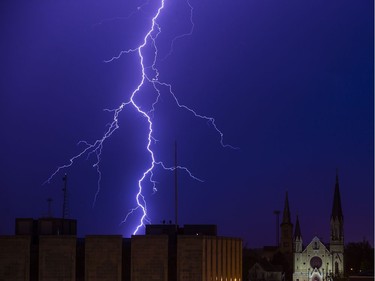 Lightning strikes Monday, May 14, 2018 west of downtown South Bend as a storm rolled through the area. (Michael Caterina/South Bend Tribune via AP) ORG XMIT: INSBE101