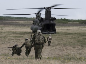 Members of the Canadian Medical Emergency Response Force Protection Team fall back to the CH -147 Chinook helicopter, during Exercise Maple Resolve in Wainwright, Alberta on the 16th of May 2018. 

Photo: Corporal Andrew Kelly, Canadian Forces Combat Camera
IS08-2018-0010-009