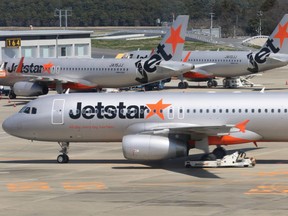 Jetstar aircraft sit parked at Terminal 3 of Narita Airport in Narita, Japan, on Wednesday, March 25, 2015.
