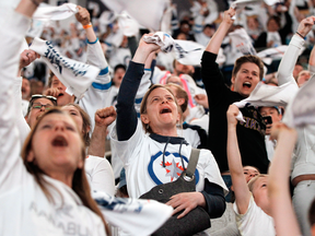 Winnipeg Jets fans cheer after their team defeated the Nashville Predators to advance to round three of the Stanley Cup playoffs.