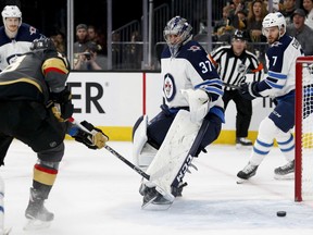 The Vegas Golden Knights' James Neal scores on Winnipeg Jets goaltender Connor Hellebuyck during the second period of Game 3 of the NHL hockey playoffs Western Conference final on Wednesday, May 16, 2018, in Las Vegas.