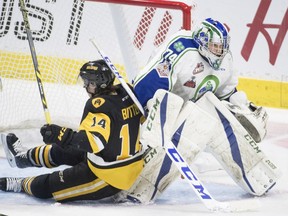 Hamilton Bulldogs forward Will Bitten (14) tries to get a shot past Swift Current Broncos goalie Stuart Skinner (74) during first period Memorial Cup action in Regina on Monday, May 21, 2018.