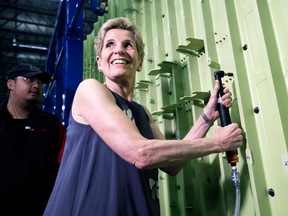 Ontario Liberal leader Kathleen Wynne puts in rivets at the MHI Canada Aerospace Inc. during a campaign stop in Mississauga on May 16, 2018.