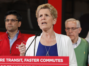 Kathleen Wynne says the legislation would require 100 per cent of unspent dollars to go towards reducing debt when the province beats its fiscal projections — something she says her party has done every year for the past four years.