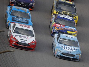 Kevin Harvick (4) leads the pack during the NASCAR Cup Series auto race at Kansas Speedway on Saturday, May 12, 2018, in Kansas City, Kan.