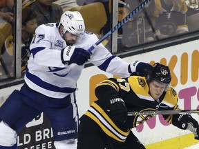 Tampa Bay Lightning left wing Alex Killorn (17) battles Boston Bruins defenseman Torey Krug (47) for position behind the Bruins' goal in the first period of Game 4 of an NHL hockey second-round playoff series Friday, May 4, 2018, in Boston.