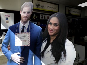 A cardboard cutout is displayed for sale in Windsor, England, Monday, May 14, 2018. Preparations are being made in the town ahead of the wedding of Britain's Prince Harry and Meghan Markle that will take place in Windsor on Saturday May 19.