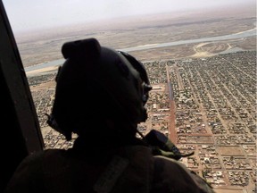 A French soldier stands inside a military helicopter in Gao, northern Mali, Friday, May 19, 2017. Canada's decision to send military helicopters to Mali has coincided with a major review of the UN peacekeeping mission, the results of which are expected in the coming weeks. The review was launched in January and its aim is to determine whether the UN mission is on the right track or needs to change to better support peace and stability in the country.