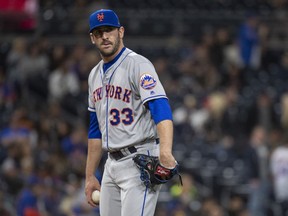 In this April 27, 2018, file New York Mets relief pitcher Matt Harvey pauses during the ninth inning of the team's baseball game against the San Diego Padres in San Diego. The Mets have traded former ace Harvey to the Cincinnati Reds for catcher Devin Mesoraco in a swap of former All-Stars with careers sidetracked by injuries.