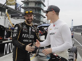 James Hinchcliffe, of Canada, talks with Josef Newgarden, right, before the final the warm up session for the IndyCar Grand Prix auto race at Indianapolis Motor Speedway in Indianapolis, Saturday, May 12, 2018.