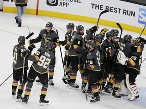 Vegas Golden Knights celebrate the team's 3-2 win against the Winnipeg Jets during Game 4 of the NHL hockey Western Conference finals Friday, May 18, 2018, in Las Vegas.