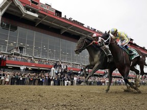 FILE - In this May 20, 2017, file photo, Cloud Computing (2), left, ridden by Javier Castellano, leads Classic Empire (5) with Julien Leparoux, to win the 142nd Preakness Stakes horse race at Pimlico RaceCourse in Baltimore. Pimlico is all gussied up again this week, ready to host the Preakness on a day that will enable the 148-year-old track to survive another year. However, the track is showing its age, and it will cost an estimated $300 million to make it right. (