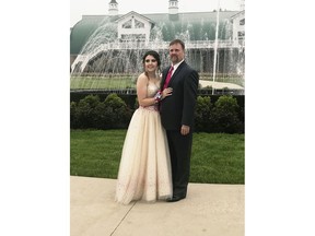 In this Saturday, May 19, 2018, photo provided by Kelly Brown, James Buchanan High School senior Kaylee Suders and Robert Brown pose for a photo at Green Grove Gardens in Greencastle, Pa. Brown, a Pennsylvania man whose son died a month before the senior prom, escorted Suders, his late son's date to the dance Saturday. Robert Brown says he knew his son would've still wanted Suders to go to the prom. Suders says she didn't want to attend after Carter's death but changed her mind when his father asked to accompany her instead.