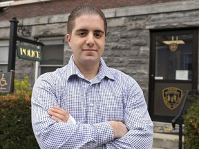 Irvington police officer Arcangelo Liberatore poses for a photo, Monday, April 30, 2018 in Irvington, N.Y. The off-duty police officer jumped on a coyote and throttled on it Sunday as the animal attacked a 5-year-old girl on a suburban New York playground. Liberatore held the coyote until the arrival of Mount Pleasant police, who shot and killed the animal. The girl needed rabies shots, stitches and antibiotics.